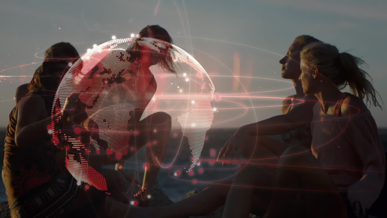 animación de una red global brillante sobre amigas felices relajándose en la playa del atardecer