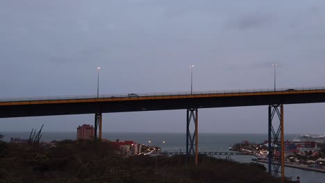 Camera-car-chase-over-the-the-Juliana-Bridge-enterance-of-the-Sint-Anna-Bay-and-a-cruise-ship-at-the-miga-pier-from-the-View-of-the-Deloitte-Dutch-Caribbean-Parking-lot-on-the-Curacao