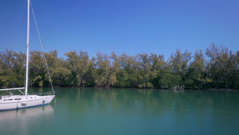 sailboat in a bay with a wreck