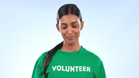 Volunteer-woman,-face-and-point-in-studio-with-t