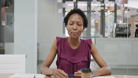 Portrait-of-african-american-businesswoman-making-video-call-in-office,-slow-motion