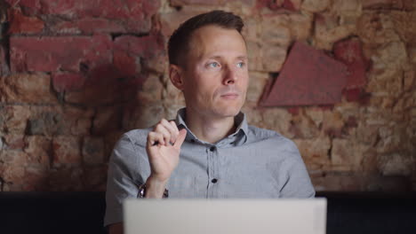 Thoughtful-serious-young-man-student-writer-sit-at-home-office-desk-with-laptop-thinking-of-inspiration-search-problem-solution-ideas-lost-in-thoughts-concept-dreaming-looking-away