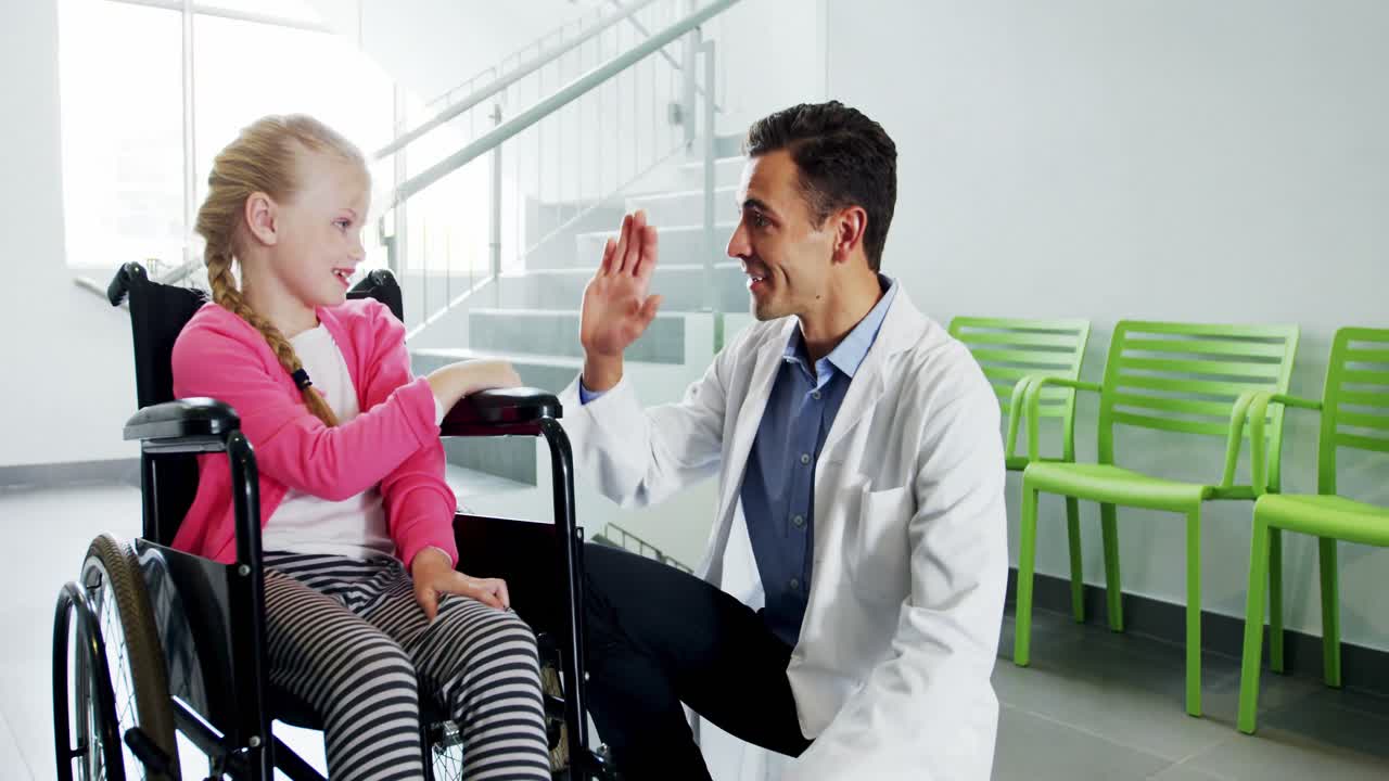 Doctor giving high five to disable girl