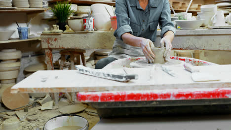 female potter molding a clay 4k