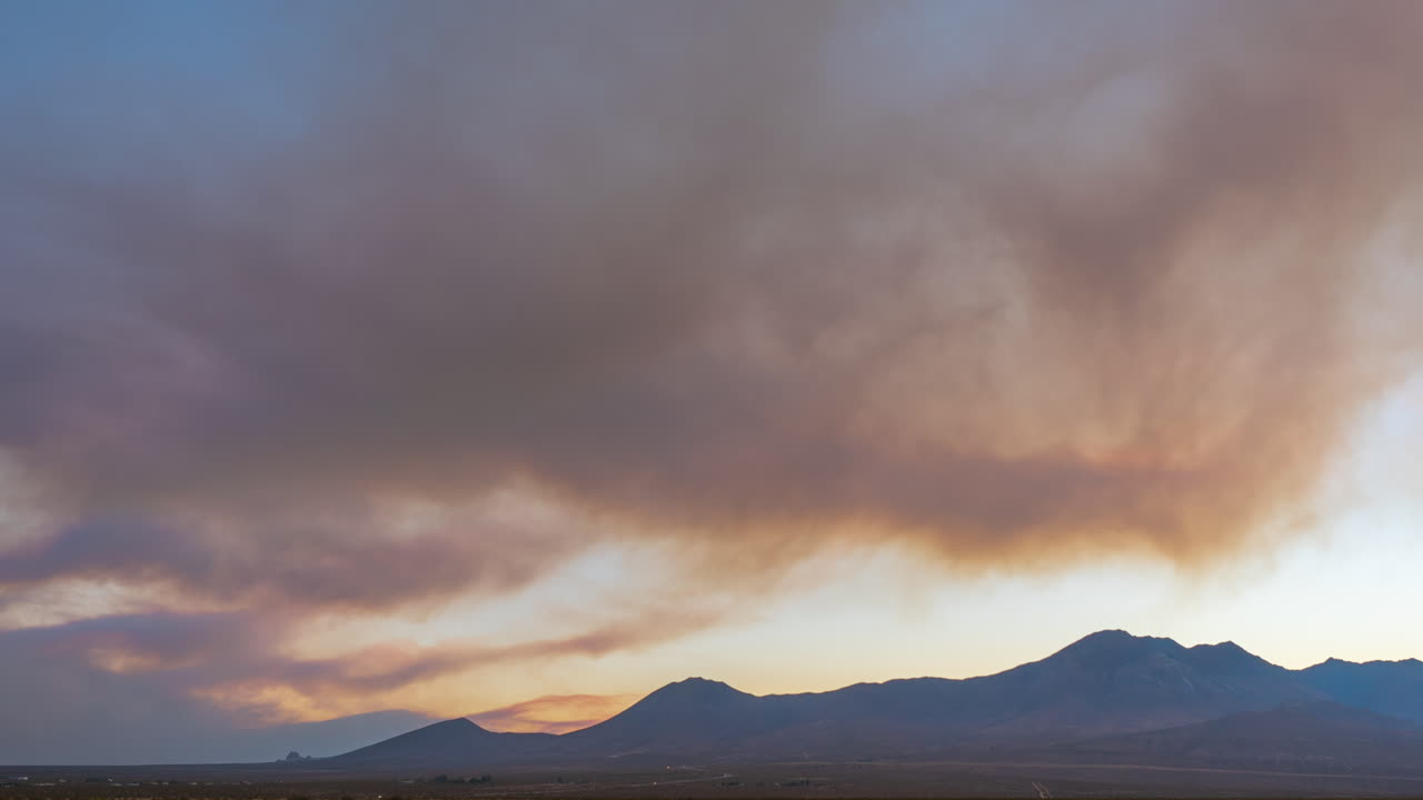 A timelapse of smoke billowing from wildfires, looking west over the Eastern Sierra Nevada range after sunset