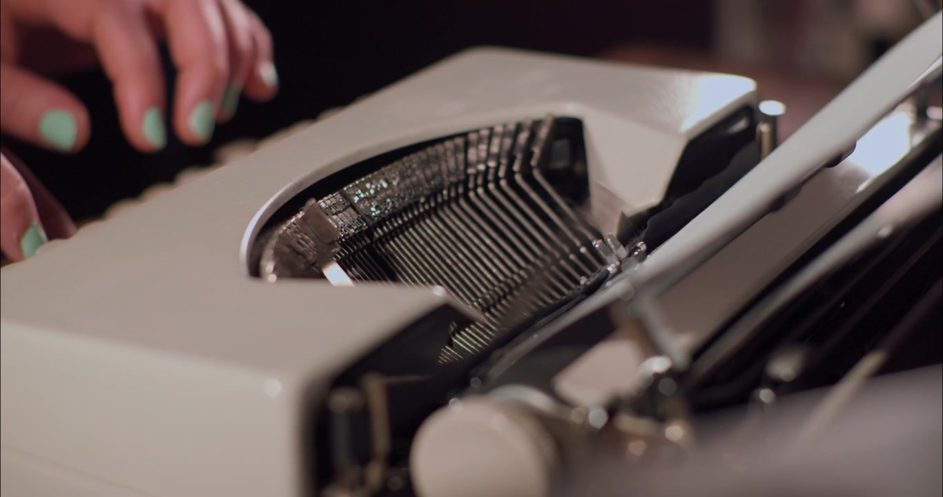 Person Typing on a Vintage Typewriter