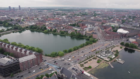 Søpavillonen-filmed-from-the-air,-nestled-between-two-lakes-and-surrounded-by-buildings-on-HC-Andersens-Boulevard