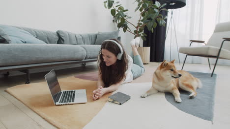 cute young female makes a video call with her dog at home 1