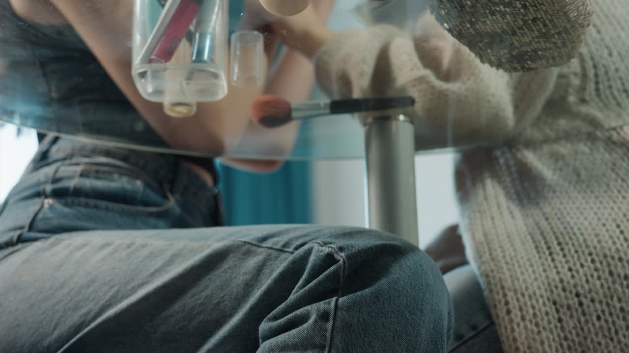 Candid Scene Of Friends Shopping, Friends Getting Ready Behind Table, Casual Moment Of Friends Preparing Makeup Accessories, Natural Scene With Friends Organizing Makeup Products Under Table