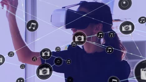 Animation-of-network-of-connections-with-icons-over-caucasian-businesswoman-using-vr-headset