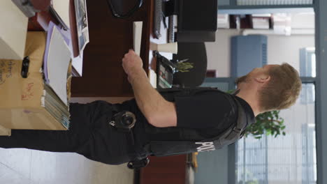 vertical shot of police officer laughing at work