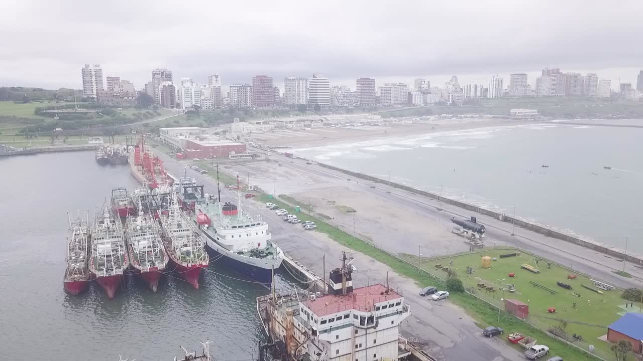 Vista Aerea di una Città Costiera con un Porto Trafficato e Navi