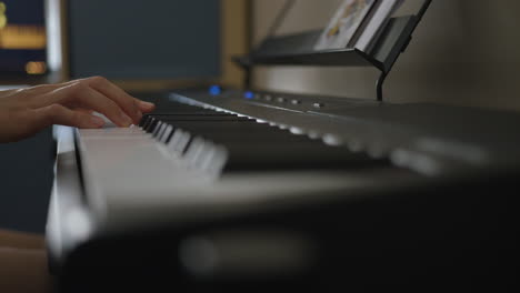 woman's hand playing an electric keyboard