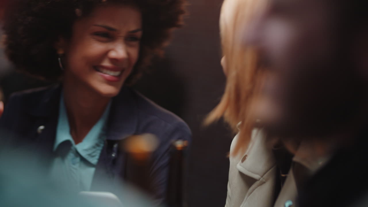happy girl friends using smartphone in restaurant browsing social media sharing reunion party enjoying friendship chatting having fun socialzing together