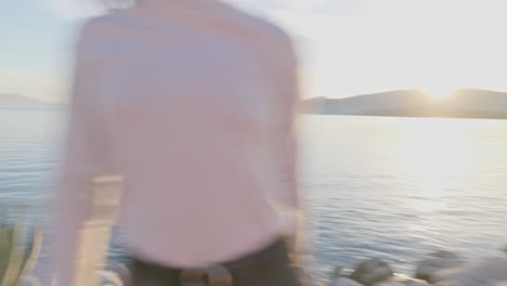 shot of a playful woman that passes by the camera and looking towards the lens as she smiles