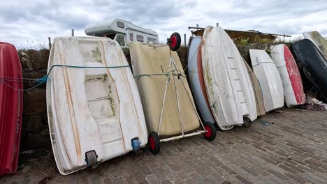 person arranging boats at dysart harbor, fife, scotland