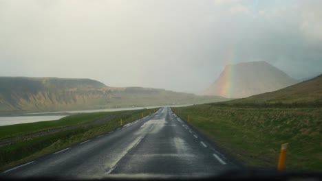driving through iceland: a scenic road trip with a rainbow