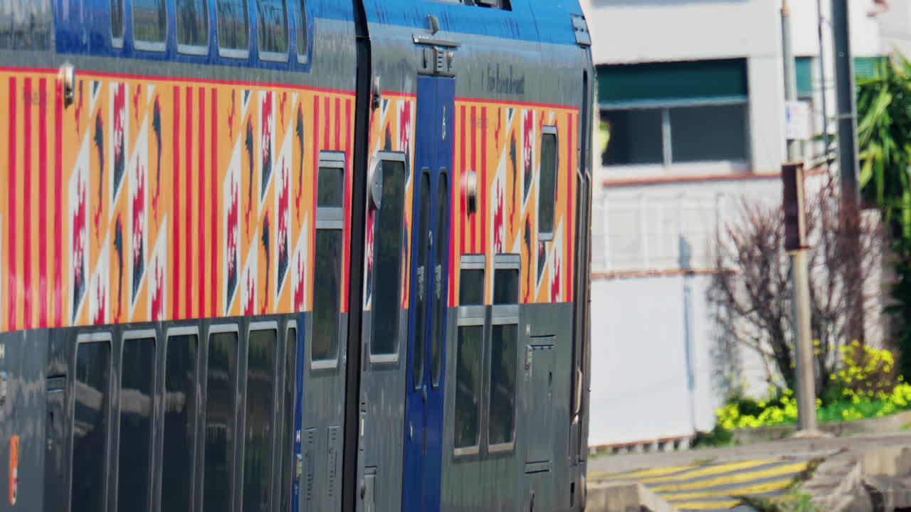 Nice, France - March 11, 2025: A blue and gray train arriving at the station in daylight
