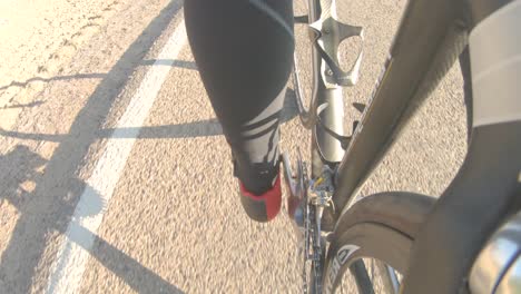 a close perspective of a cyclist focused on the peddling - this is a loopable clip