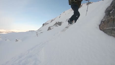 Still-shot-man-equipped-snowshoe-walking-on-snow-up-hill---Norway