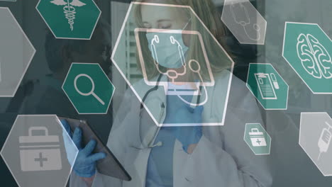 animation of medical icons over caucasian female doctor in face mask