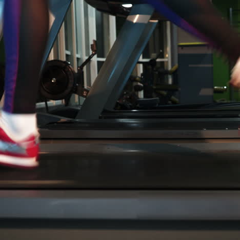 Female muscular feet in sneakers running on the treadmill at the gym. Concept for fitness, exercising and healthy lifestyle. Square video