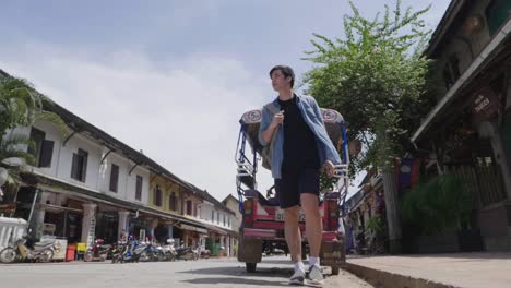 young man exploring luang prabang, laos