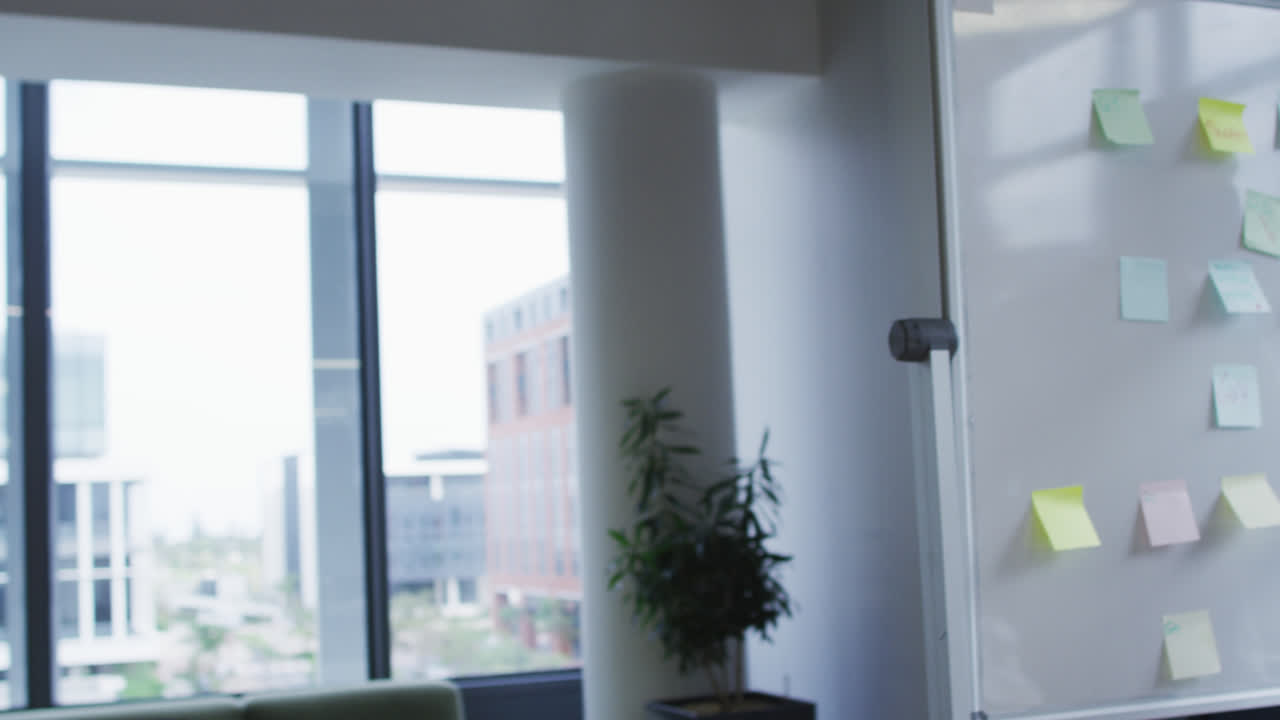 diversos colegas masculinos creativos con máscaras faciales haciendo lluvia de ideas y trabajando en una oficina ocupada