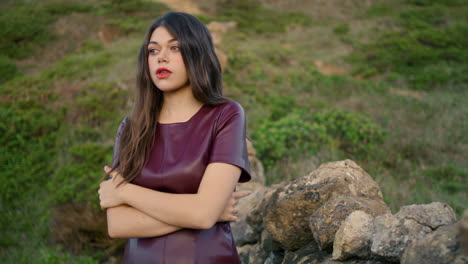 Woman-relaxing-walking-hill-near-rocky-wall-closeup.-Brunette-enjoy-calm-leisure