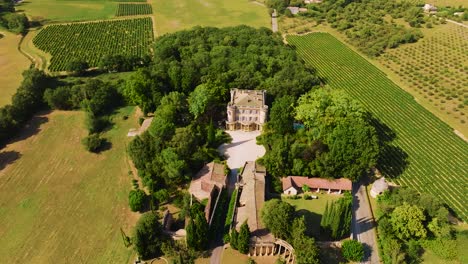 High-aerial-orbiting-shot-showing-the-Chateau-de-Castille-in-the-countryside-in-Uzes