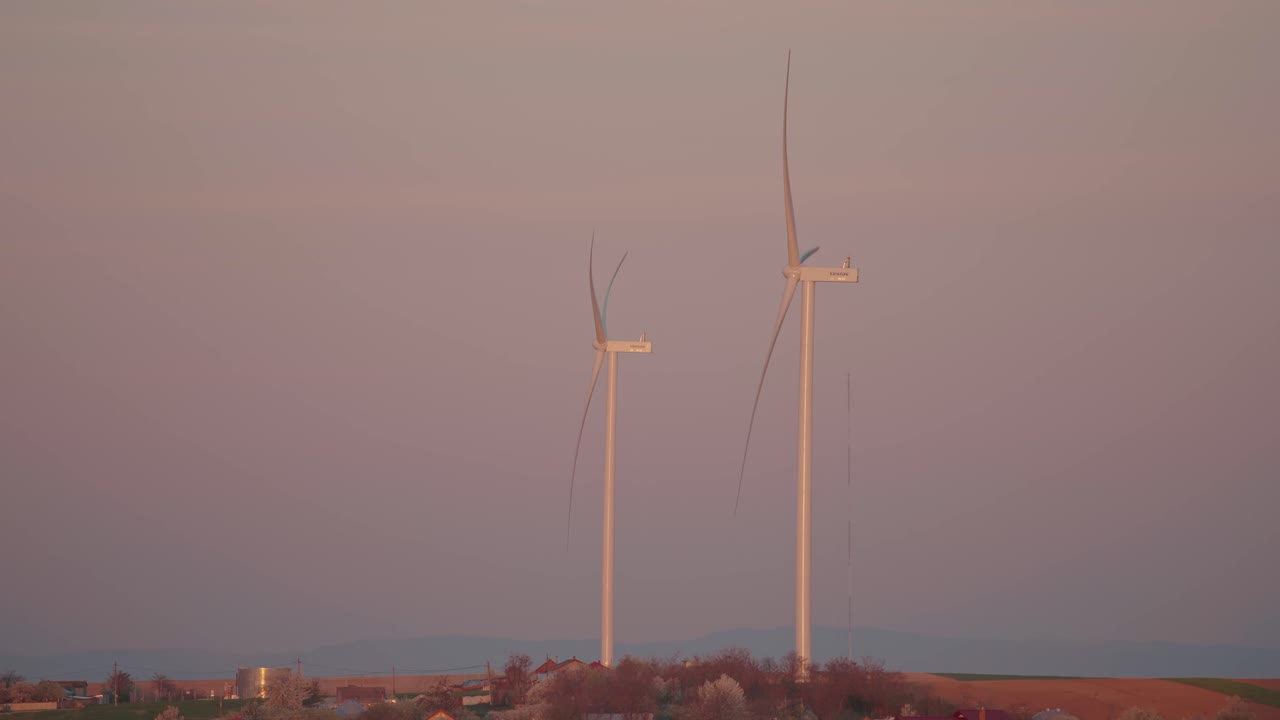 Wind Turbines Against a Pink and Purple Sky