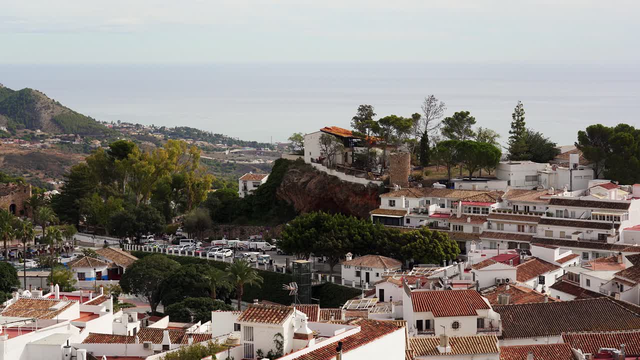 View over the root tops of the famous white town of Mijas in the hills over looking the Costa del Sol and Mediterranean Sea. Spain
