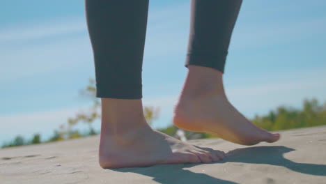 Woman's-feet-walking-in-sand.-Slow-Motion