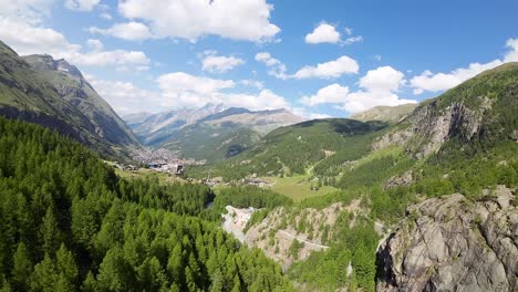 Flight-over-a-forest-in-the-beautiful-Swiss-Alps-mountains-with-the-Zermatt-town-in-the-background