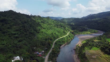 panoramic aerial view above wide river gorge and winding two lane mountain road