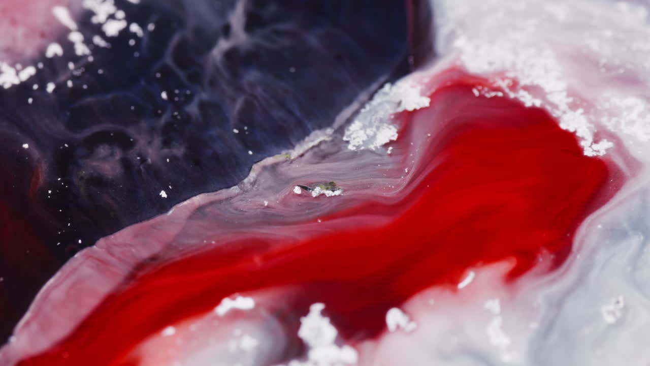 Abstract fluid macro of red white and blue marble texture, slow motion