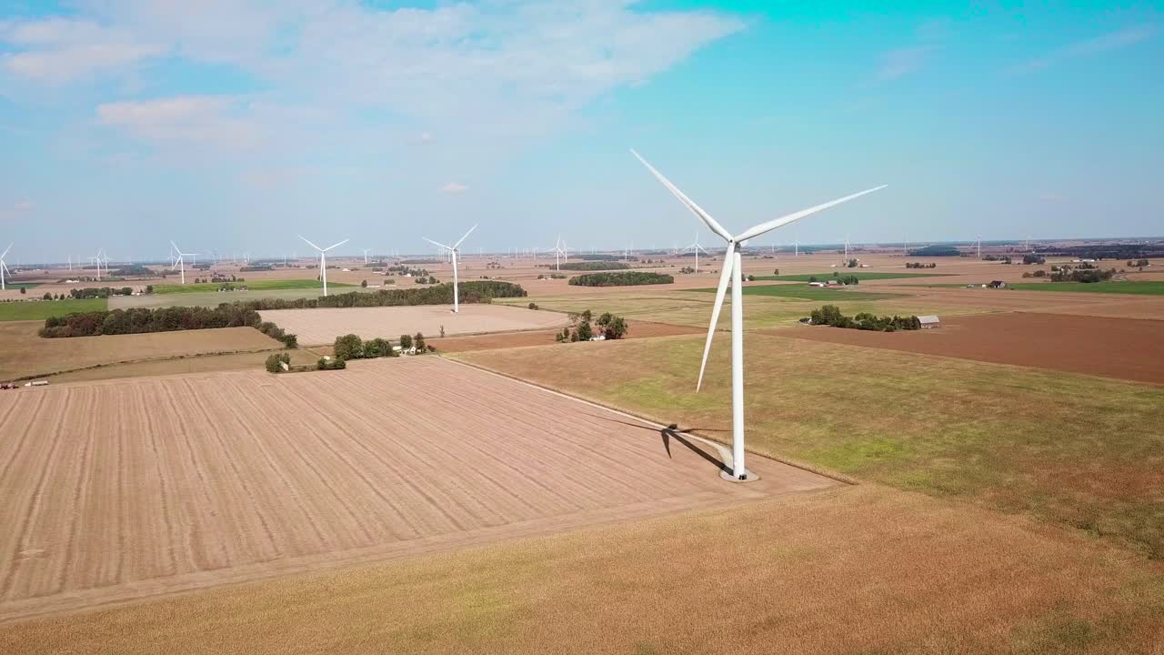 Aerial over a wind turbine producing alternative electricity in rural Michigan 1