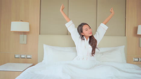 asian woman wake up in a hotel room in the morning