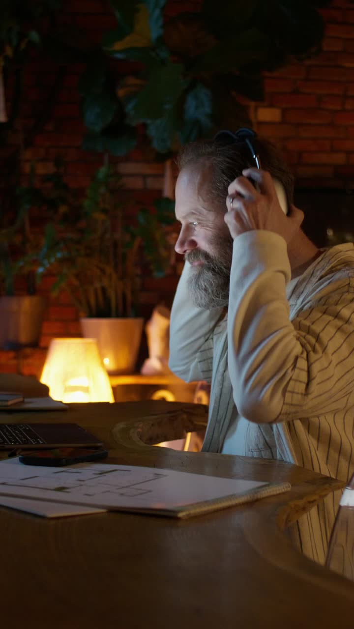 Man Working on Design Plans at Home at Night