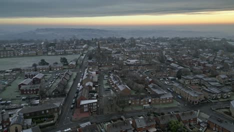 4k cinematic aerial footage, depicting a harsh english winter cold spell with mist and freezing temperatures