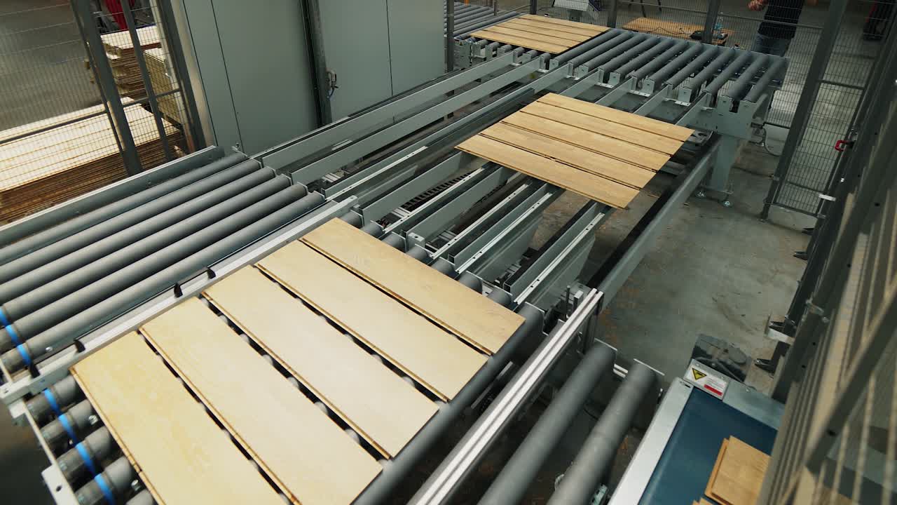 wooden boards are processing at the automated line of plant for the parquet manufacturing. Woodworking industry