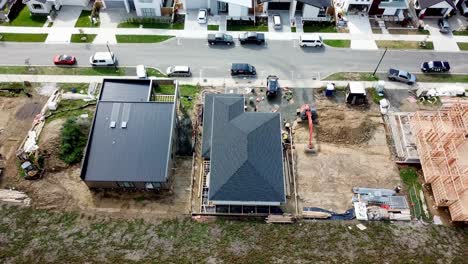 aerial-top-view-of-a-new-suburb,-with-new-houses-building-in-progress