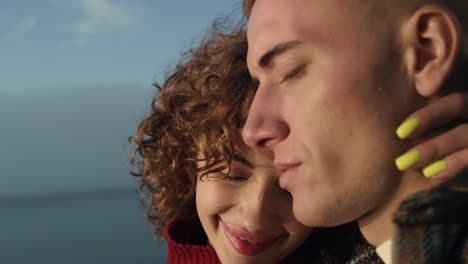 sensual woman embracing man on beach. happy couple enjoying romantic date