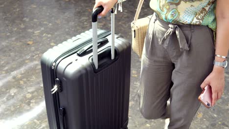 young beautiful woman with travel bag from the terminal at the airport or train station