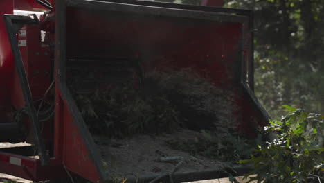Tree chipper shredding tree limb action shot
