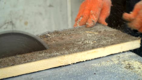 circular saw. the wizard cuts a wooden board on a circular saw. close-up.