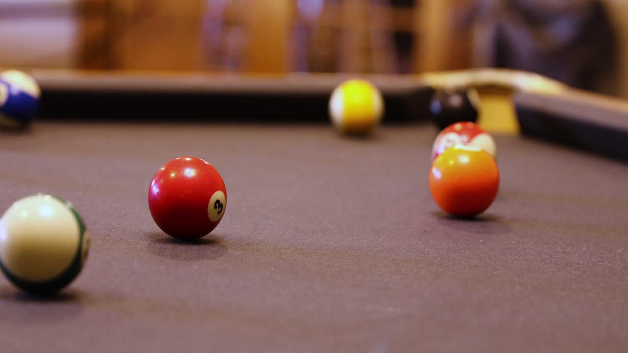 Premium stock video Playing a game of pool with balls rolling over