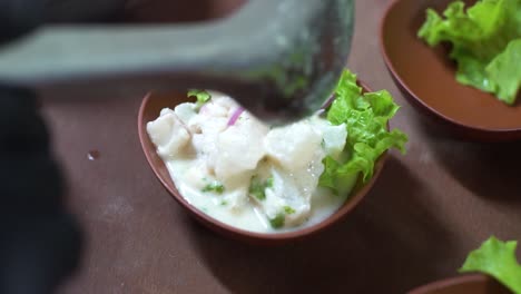 chef serving ceviche typical peruvian dish, traditional peruvian food made with fish