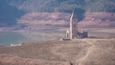 old buildings emerging from empty swamp due to the problems of extreme dryness and lack of rain