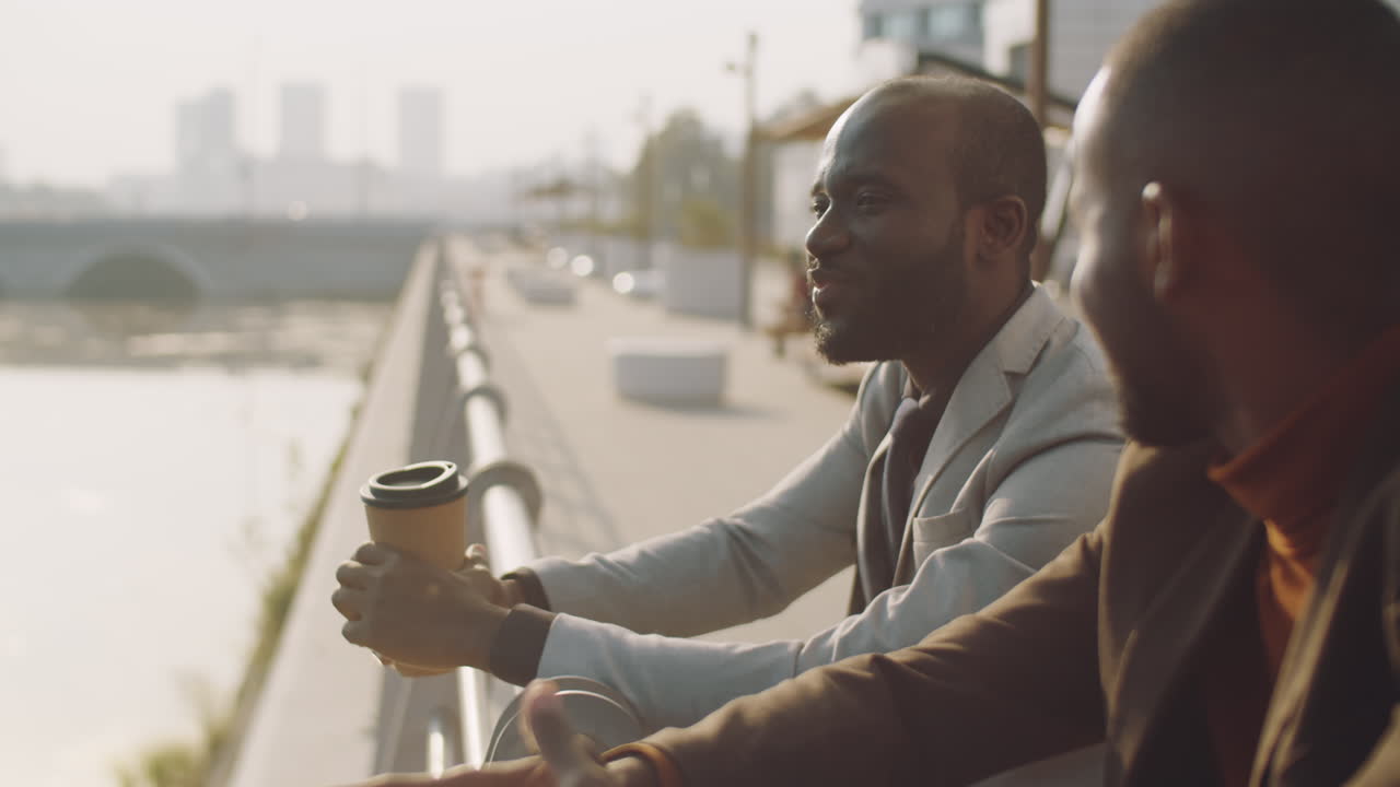 African American Businessmen Chatting on Embankment in City